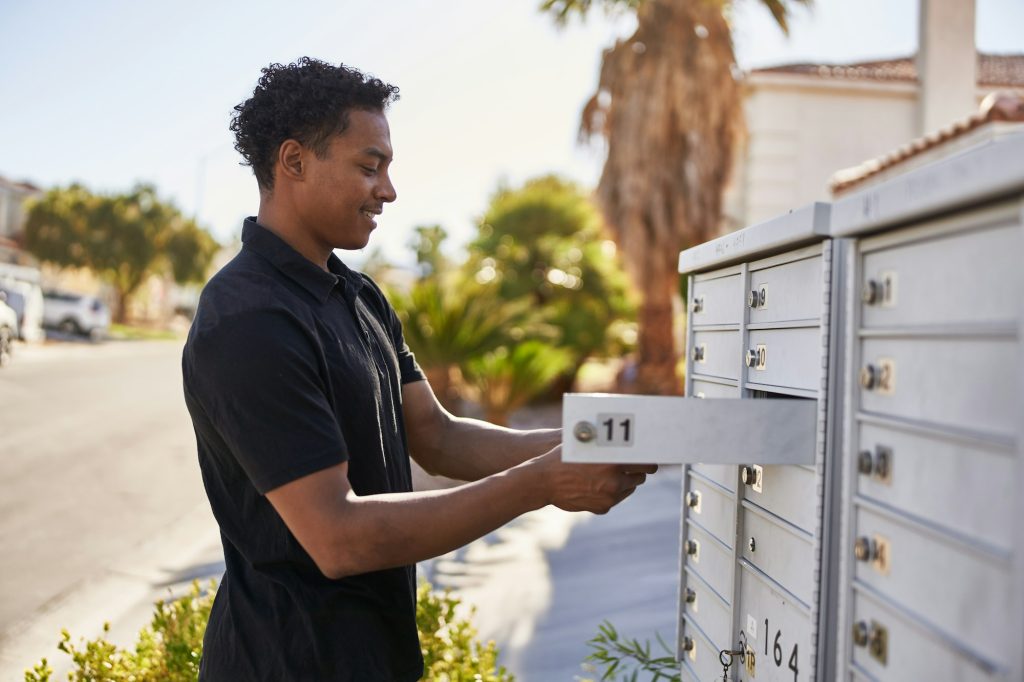 african american man checking community mail box in las vegas